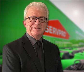 Man in suit in front of a SERVPRO Trailer background